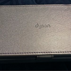 Dyson hair dryer case and two attachments.